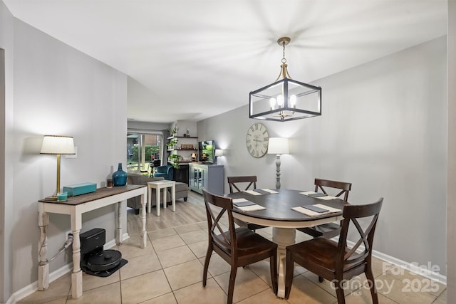 2533 Stockbridge Dr, Charlotte, NC 28210 - dining area featuring light tile patterned floors, a chandelier, and baseboards