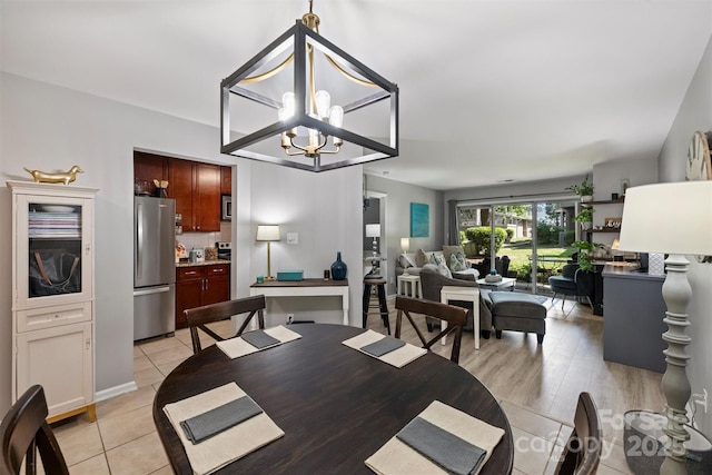 2533 Stockbridge Dr, Charlotte, NC 28210 - dining space featuring light tile patterned flooring and a chandelier
