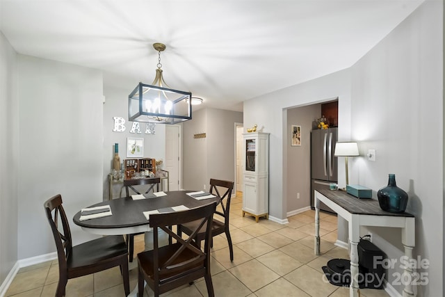 2533 Stockbridge Dr, Charlotte, NC 28210 - dining area featuring light tile patterned flooring, a chandelier, and baseboards