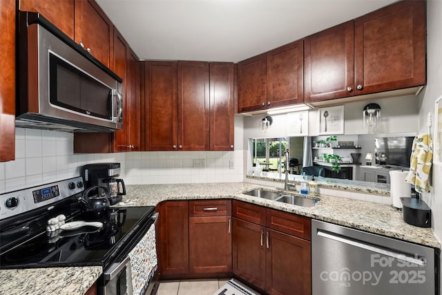 2533 Stockbridge Dr, Charlotte, NC 28210 - kitchen featuring appliances with stainless steel finishes, a sink, tasteful backsplash, and light stone counters
