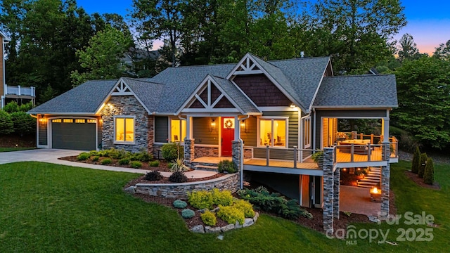 15 Ledgestone Dr, Fairview, NC 28730 - craftsman inspired home featuring a front lawn, stone siding, a garage, and roof with shingles