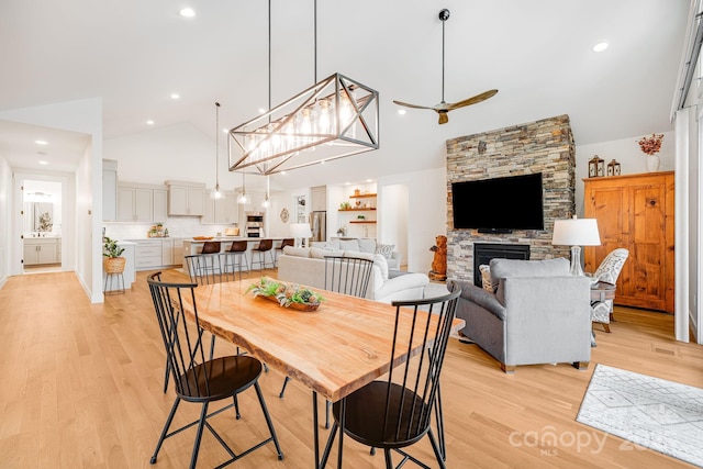 15 Ledgestone Dr, Fairview, NC 28730 - dining space with high vaulted ceiling, a ceiling fan, light wood-type flooring, recessed lighting, and a stone fireplace