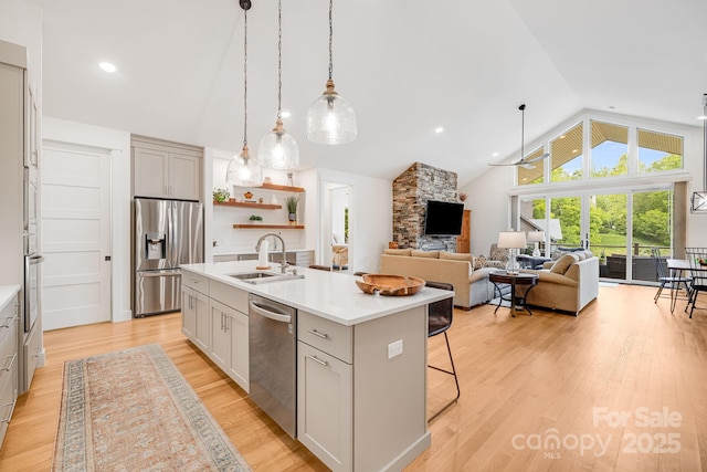15 Ledgestone Dr, Fairview, NC 28730 - kitchen with appliances with stainless steel finishes, a sink, a kitchen island with sink, light countertops, and a kitchen bar