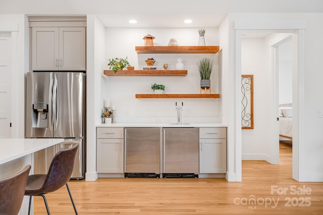 15 Ledgestone Dr, Fairview, NC 28730 - indoor wet bar featuring stainless steel fridge, light wood finished floors, refrigerator, recessed lighting, and baseboards