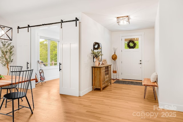 15 Ledgestone Dr, Fairview, NC 28730 - entrance foyer featuring light wood-style flooring, plenty of natural light, and a barn door