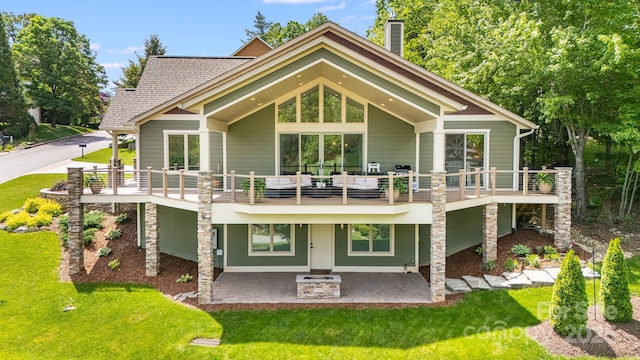 15 Ledgestone Dr, Fairview, NC 28730 - back of house with a lawn, a chimney, a patio area, and roof with shingles