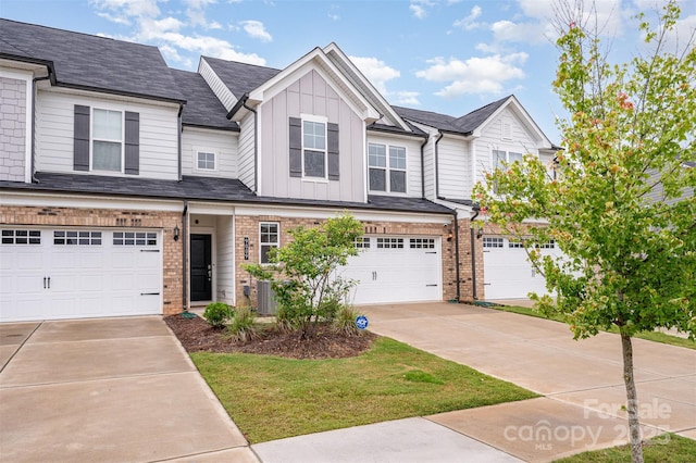9009 Odell Corners Blvd NW, Concord, NC 28027 - view of front of home with board and batten siding, concrete driveway, a garage, and brick siding