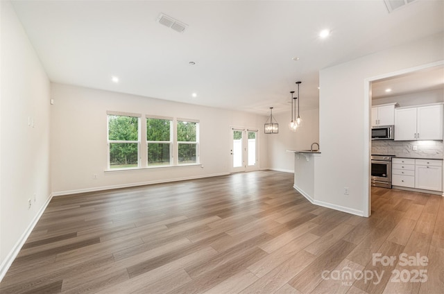 9009 Odell Corners Blvd NW, Concord, NC 28027 - unfurnished living room featuring light wood-style flooring, recessed lighting, and baseboards