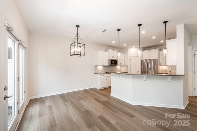 9009 Odell Corners Blvd NW, Concord, NC 28027 - kitchen featuring stainless steel appliances, light wood-style flooring, backsplash, and recessed lighting