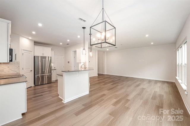 9009 Odell Corners Blvd NW, Concord, NC 28027 - kitchen with freestanding refrigerator, light wood-style floors, recessed lighting, backsplash, and a peninsula