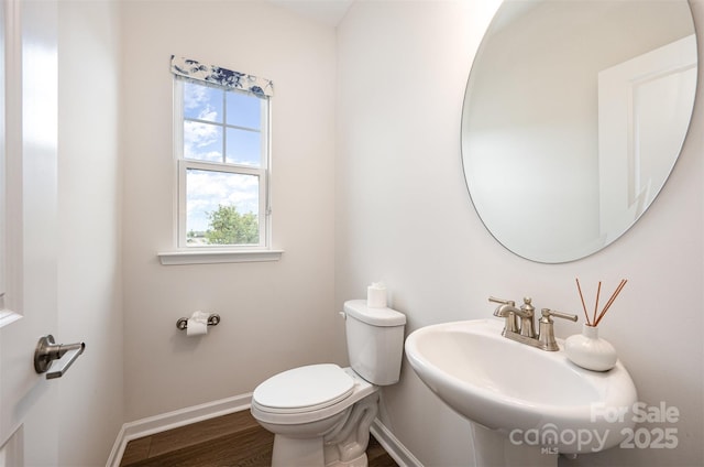 9009 Odell Corners Blvd NW, Concord, NC 28027 - half bathroom featuring baseboards, toilet, wood finished floors, and a sink