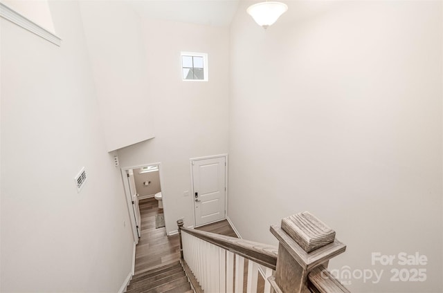 9009 Odell Corners Blvd NW, Concord, NC 28027 - stairway with wood finished floors, baseboards, and a high ceiling