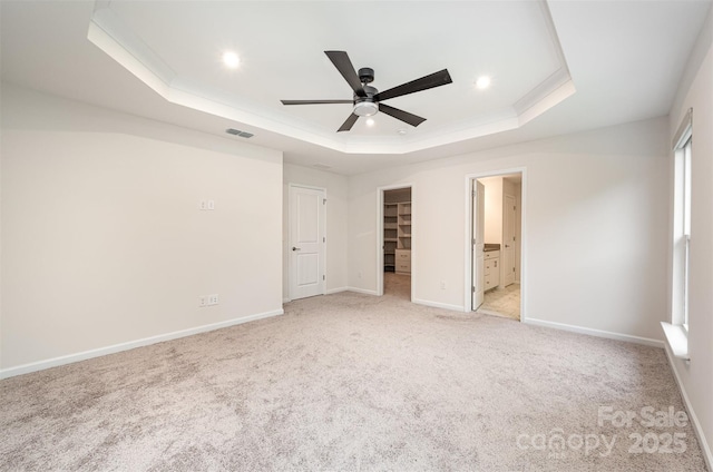 9009 Odell Corners Blvd NW, Concord, NC 28027 - unfurnished bedroom with a raised ceiling, light colored carpet, a spacious closet, baseboards, and ornamental molding