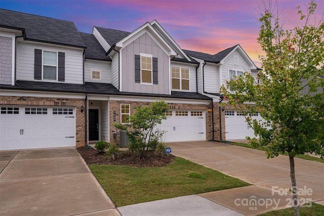 9009 Odell Corners Blvd NW, Concord, NC 28027 - view of property featuring driveway, board and batten siding, a garage, and brick siding