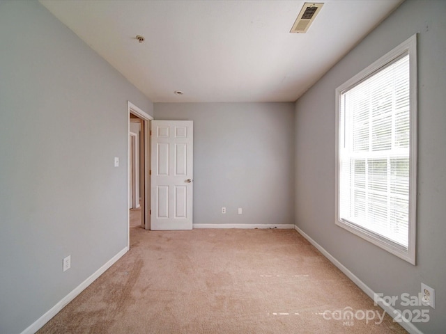 1023 Triece Ln, Charlotte, NC 28215 - spare room with light colored carpet, baseboards, and fire sprinkler in ceiling