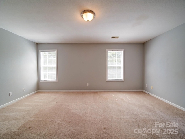1023 Triece Ln, Charlotte, NC 28215 - unfurnished room featuring plenty of natural light, carpet floors, and baseboards