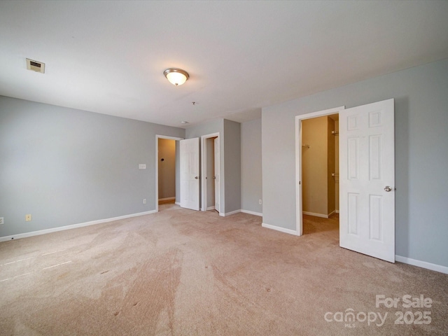 1023 Triece Ln, Charlotte, NC 28215 - unfurnished bedroom with carpet flooring, baseboards, and a walk in closet