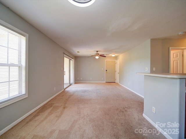 1023 Triece Ln, Charlotte, NC 28215 - empty room featuring light colored carpet, healthy amount of natural light, and a ceiling fan