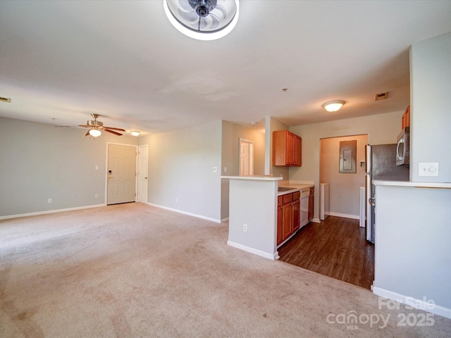 1023 Triece Ln, Charlotte, NC 28215 - kitchen with stainless steel microwave, dishwasher, electric panel, carpet, and light countertops