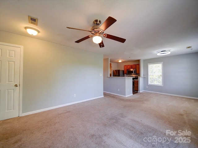 1023 Triece Ln, Charlotte, NC 28215 - unfurnished living room featuring light colored carpet, baseboards, and a ceiling fan