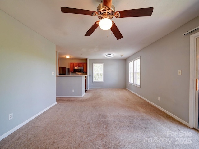 1023 Triece Ln, Charlotte, NC 28215 - unfurnished living room with baseboards, light colored carpet, and a ceiling fan