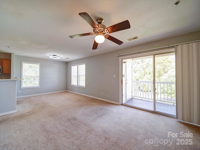 1023 Triece Ln, Charlotte, NC 28215 - spare room featuring baseboards, light colored carpet, ceiling fan, and fire sprinkler in ceiling