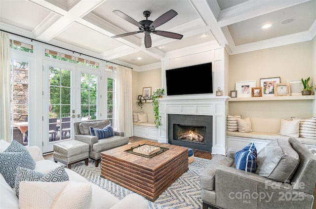 6873 Pine Moss Ln, Clover, SC 29710 - living room with coffered ceiling, crown molding, french doors, a warm lit fireplace, and wood finished floors