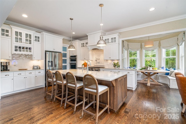 6873 Pine Moss Ln, Clover, SC 29710 - kitchen with appliances with stainless steel finishes, light countertops, dark wood-type flooring, white cabinets, and ornamental molding