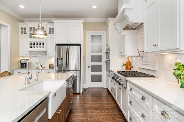 6873 Pine Moss Ln, Clover, SC 29710 - kitchen with stainless steel appliances, custom exhaust hood, glass insert cabinets, white cabinetry, and recessed lighting