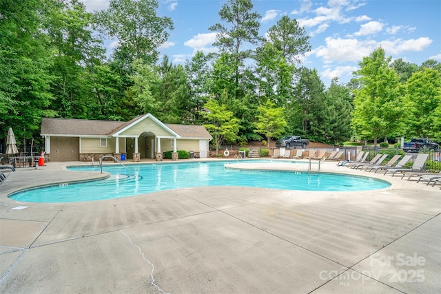 6873 Pine Moss Ln, Clover, SC 29710 - community pool featuring a patio area and view of wooded area