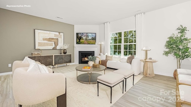 3734 Coleman Dr, Charlotte, NC 28215 - living area with baseboards, wood finished floors, and a glass covered fireplace