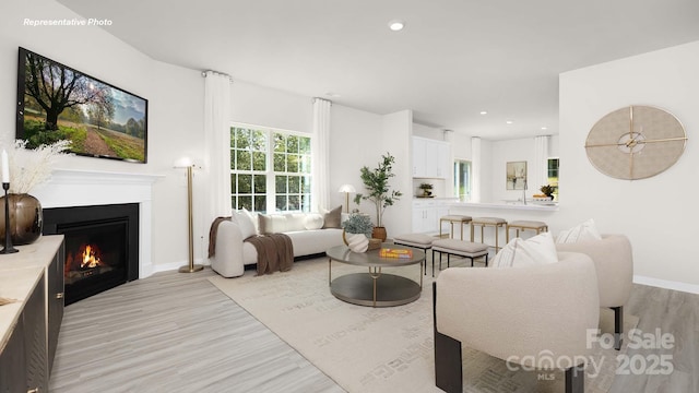 3734 Coleman Dr, Charlotte, NC 28215 - living area featuring light wood-style floors, a warm lit fireplace, baseboards, and recessed lighting