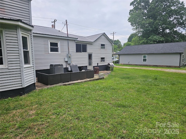 905 Klondale St, China Grove, NC 28023 - rear view of property with an outdoor living space, a yard, metal roof, central air condition unit, and a chimney