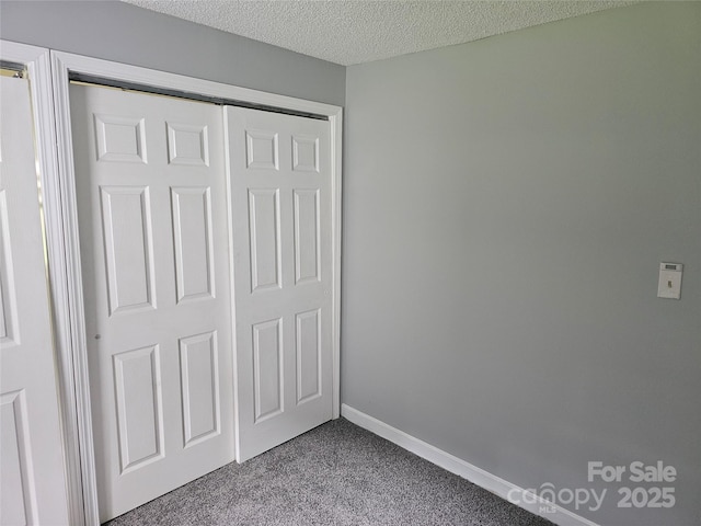 905 Klondale St, China Grove, NC 28023 - unfurnished bedroom with carpet floors, a closet, a textured ceiling, and baseboards