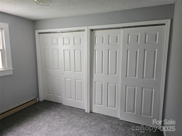 905 Klondale St, China Grove, NC 28023 - unfurnished bedroom featuring dark carpet, baseboard heating, and a textured ceiling
