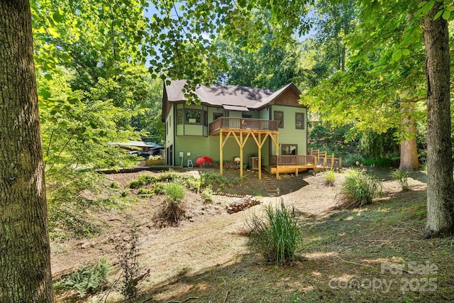 6 Woodland Rd W, Asheville, NC 28806 - rear view of house with a wooden deck and a shingled roof