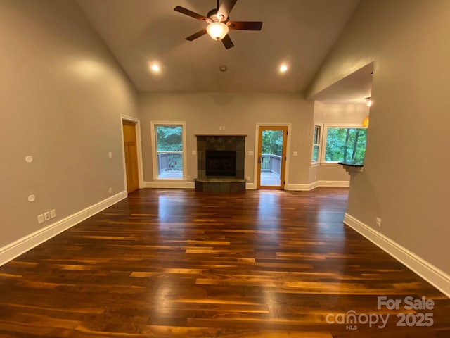 6 Woodland Rd W, Asheville, NC 28806 - unfurnished living room with high vaulted ceiling, a ceiling fan, baseboards, dark wood-type flooring, and a tile fireplace