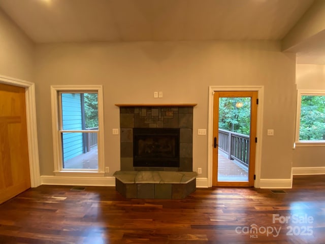 6 Woodland Rd W, Asheville, NC 28806 - unfurnished living room featuring wood finished floors, a tile fireplace, and baseboards