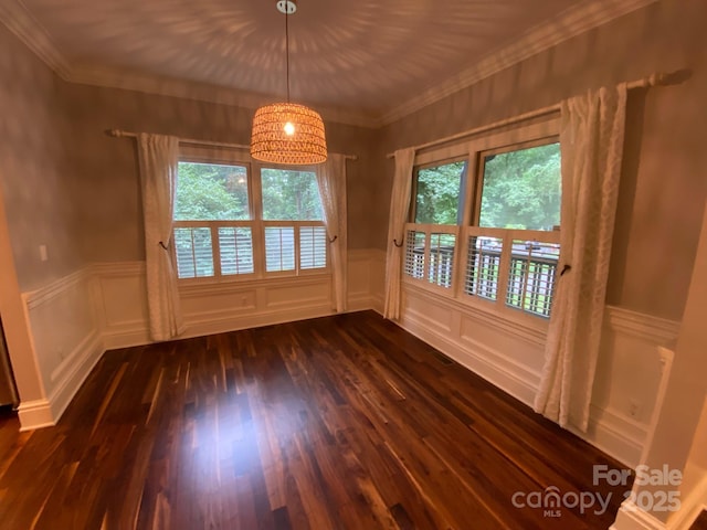 6 Woodland Rd W, Asheville, NC 28806 - unfurnished dining area with plenty of natural light, dark wood-style floors, a decorative wall, wainscoting, and crown molding