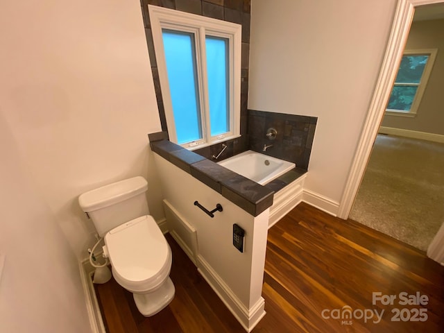 6 Woodland Rd W, Asheville, NC 28806 - bathroom featuring toilet, baseboards, wood finished floors, a sink, and a bathtub
