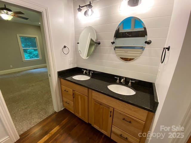 6 Woodland Rd W, Asheville, NC 28806 - bathroom with double vanity, wood finished floors, ceiling fan, and baseboards