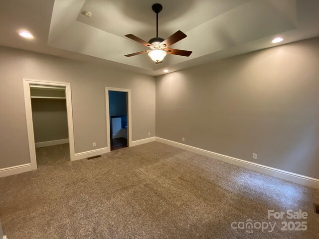 6 Woodland Rd W, Asheville, NC 28806 - unfurnished bedroom with a walk in closet, carpet floors, a tray ceiling, baseboards, and recessed lighting