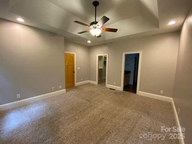 6 Woodland Rd W, Asheville, NC 28806 - unfurnished bedroom with a spacious closet, carpet, baseboards, recessed lighting, and a tray ceiling