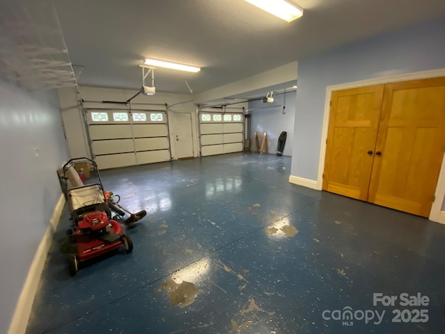 6 Woodland Rd W, Asheville, NC 28806 - garage featuring a garage door opener and baseboards