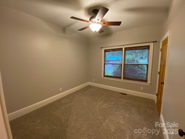 6 Woodland Rd W, Asheville, NC 28806 - empty room featuring dark colored carpet, ceiling fan, and baseboards