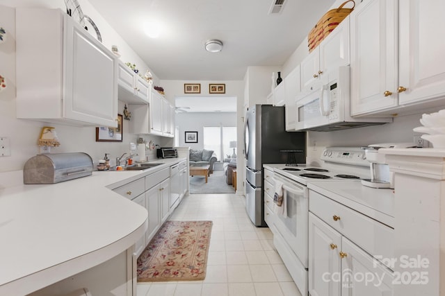 12350 Swan Wings Pl, Huntersville, NC 28078 - kitchen with white appliances, a sink, white cabinetry, light countertops, and light tile patterned flooring