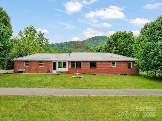 391 Ellen Ave, Canton, NC 28716 - rear view of house featuring a lawn, brick siding, a mountain view, and metal roof