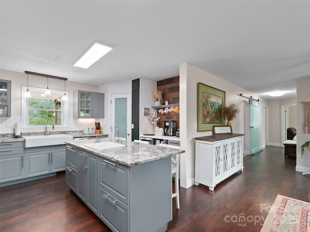 391 Ellen Ave, Canton, NC 28716 - kitchen featuring gray cabinetry, a sink, glass insert cabinets, and dark wood finished floors