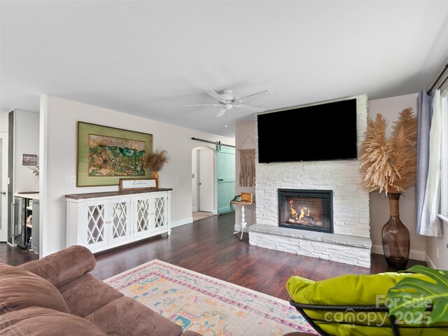 391 Ellen Ave, Canton, NC 28716 - living area with ceiling fan, a fireplace, wood finished floors, baseboards, and arched walkways