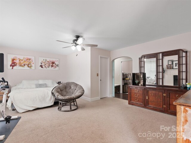 391 Ellen Ave, Canton, NC 28716 - bedroom featuring arched walkways, light carpet, baseboards, and a ceiling fan